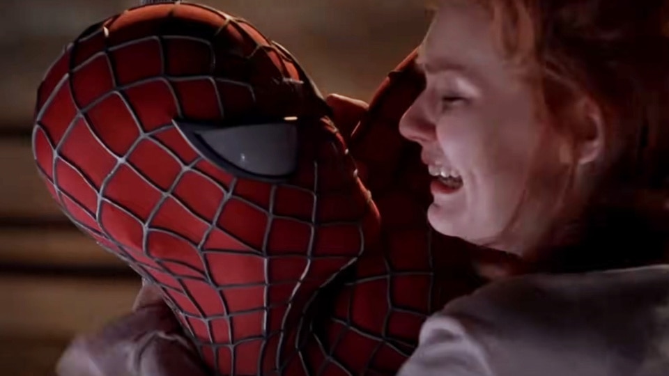 Spider-Man (Tobey Maguire) embraces a panicking Mary Jane Watson (Kirsten Dunst) in Spider-Man (2002).