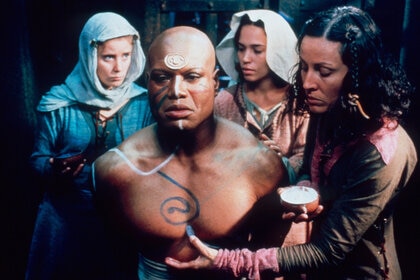 Christopher Judge as Teal'c in Stargate SG-1 115 is tended to by three women
