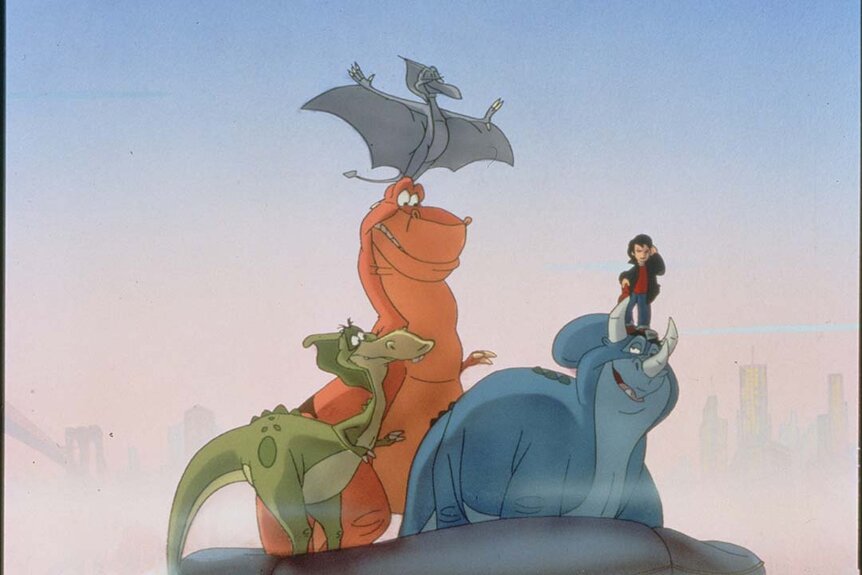 Louie (Joey Shea) stands on a dinosaur while other dinosaurs watch in We're Back! A Dinosaur's Story (1993).